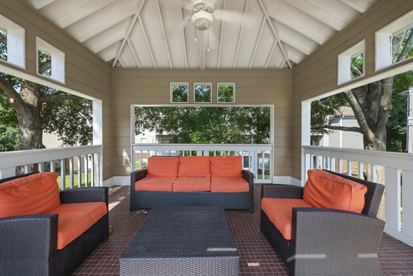 Outdoor patio area at Concord Apartments featuring modern seating and lush greenery for relaxing atmosphere