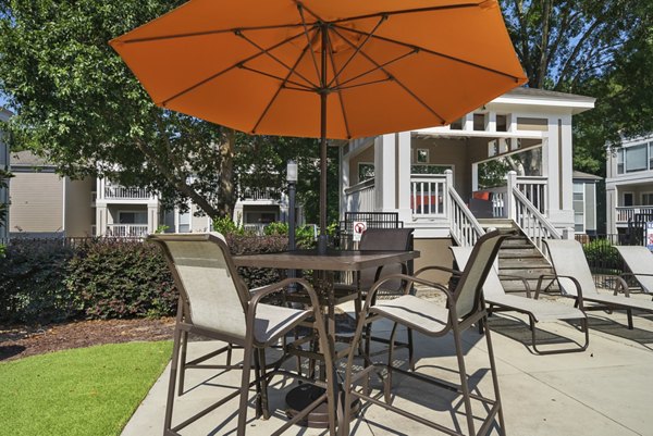 Stylish outdoor patio with modern seating at Concord Apartments, perfect for relaxation and social gatherings