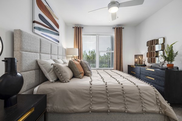 Cozy bedroom with modern decor at The Easley Apartments: luxury living in stylish surroundings
