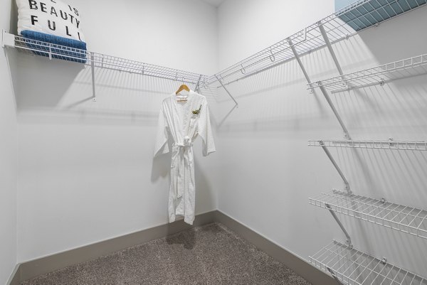 Spacious walk-in closet with built-in shelving at The Easley Apartments