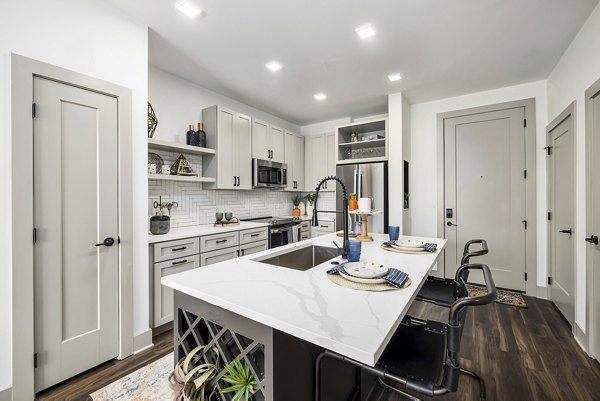 Modern kitchen with stainless steel appliances at The Easley Apartments