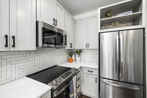 Modern kitchen featuring stainless steel appliances at The Easley Apartments