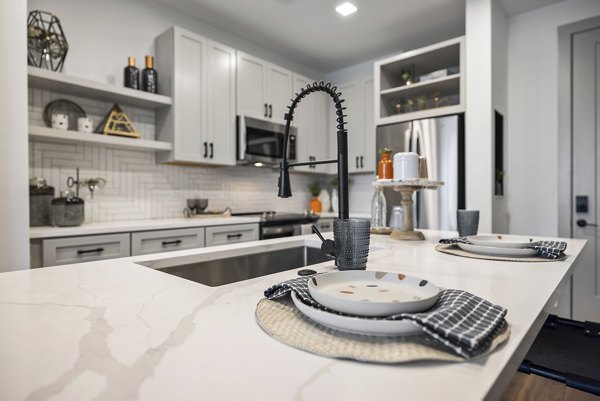 Modern kitchen with stainless steel appliances at The Easley Apartments