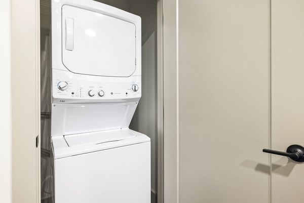 Laundry room featuring modern appliances at The Easley Apartments in Greystar's luxury community