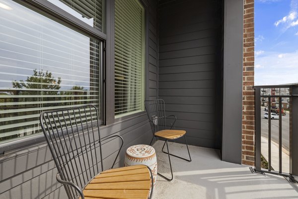 Spacious outdoor patio area with modern seating at The Easley Apartments, perfect for relaxation and social gatherings