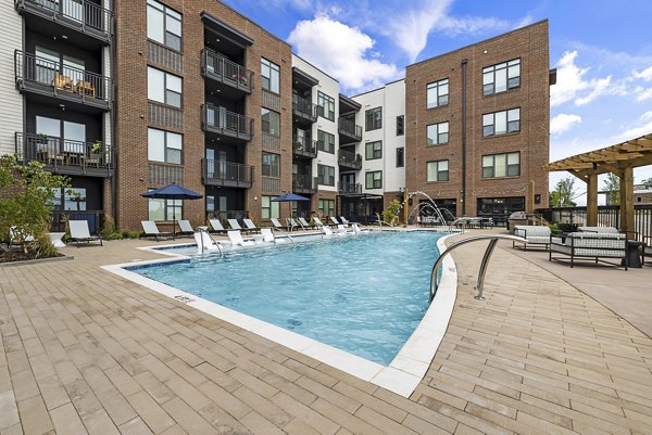 Luxurious pool area with lounging chairs at The Easley Apartments, perfect for relaxation and leisure activities