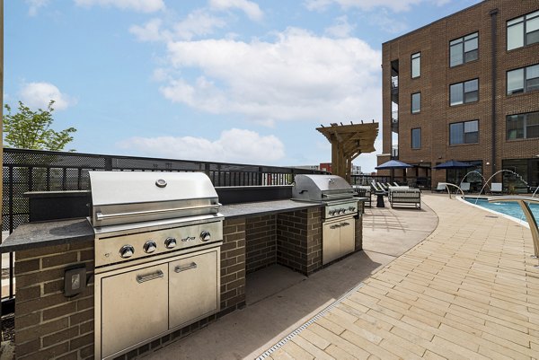 Grill area with modern outdoor seating at The Easley Apartments