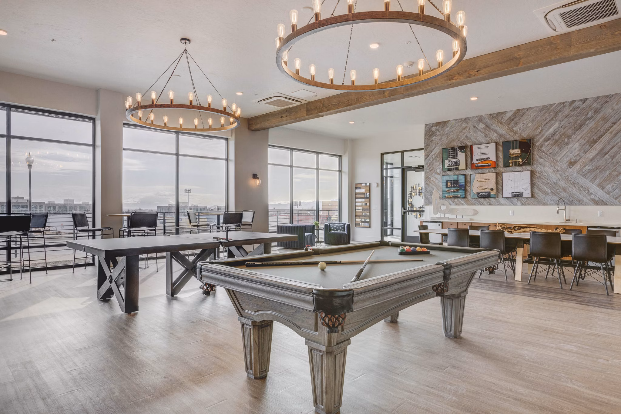 Game room with arcade machines and billiards at The Heights at Legend Hills Apartments Fun community space for residents to unwind and socialize