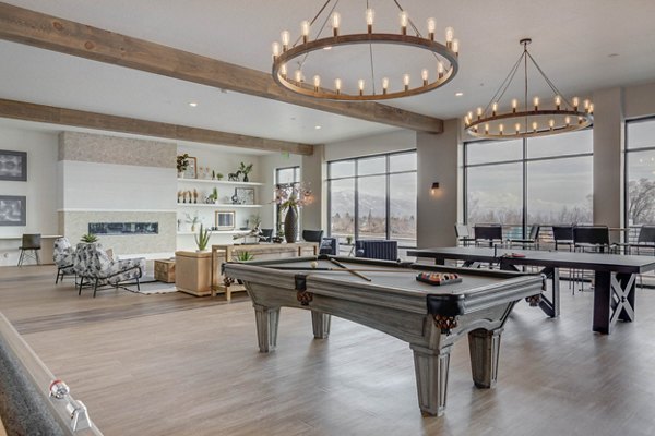 Modern game room with pool table and lounge seating at The Heights at Legend Hills Apartments