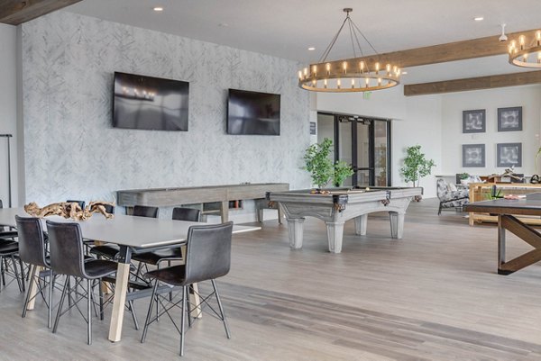 Clubhouse with modern seating and large windows at The Heights at Legend Hills Apartments
