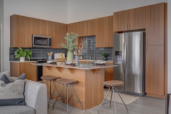 Kitchens with stainless steel appliances in The Heights at Legend Hills Apartments, a Greystar community