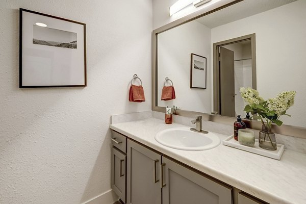 Modern bathroom featuring sleek fixtures and ample lighting at Shift Apartments