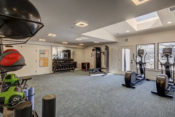 Shift Apartments: Modern fitness center with state-of-the-art equipment and vibrant design, perfect for active lifestyles