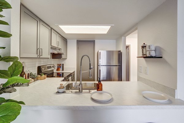 Modern kitchen with sleek countertops and stainless steel appliances at Shift Apartments