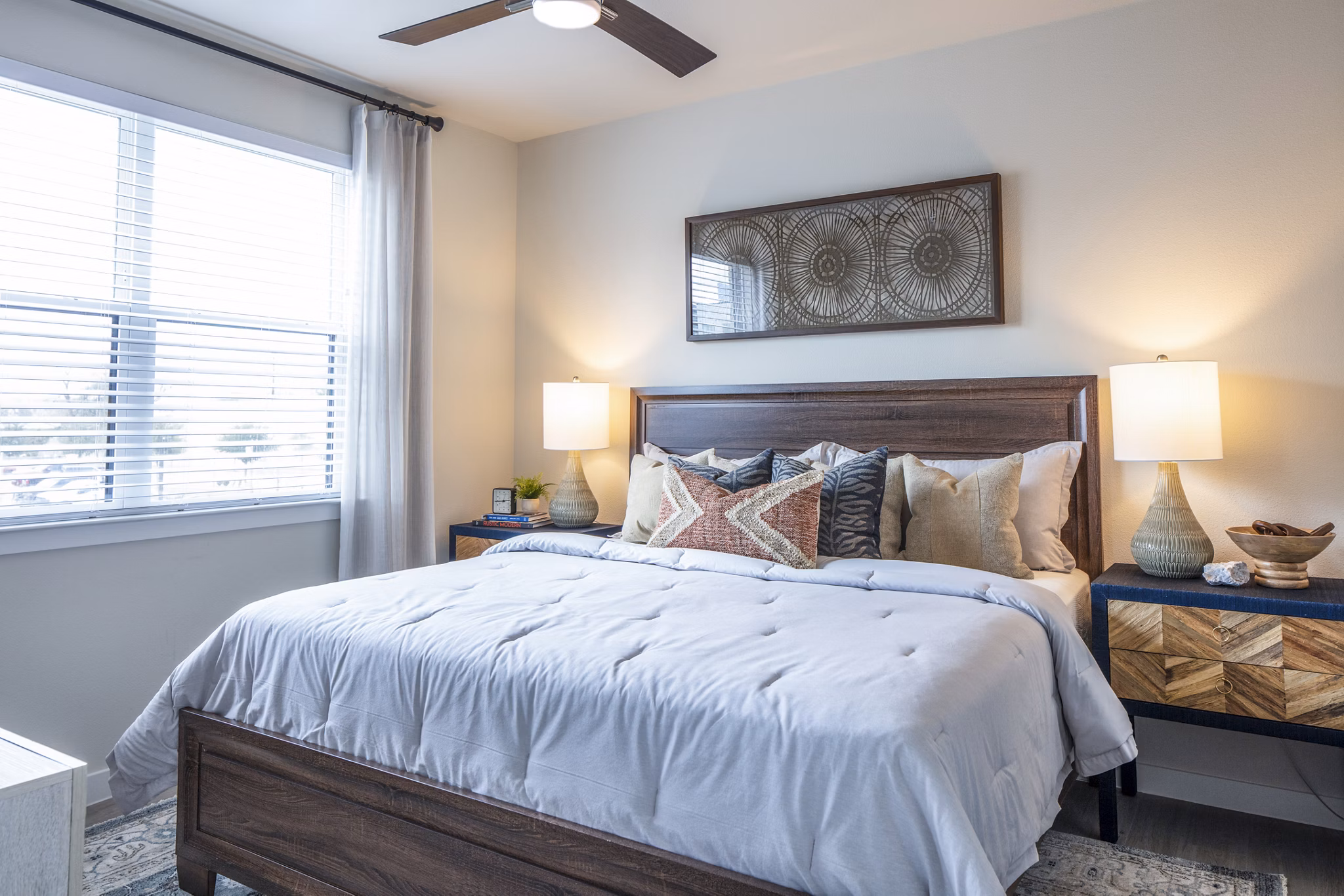 Stylish bedroom featuring large windows and modern decor at Prose Hardy Yards Apartments