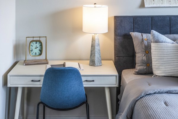 Bedroom with home office setup at Prose Hardy Yards Apartments, featuring ergonomic desk and cozy bedding Perfect for remote work and relaxation