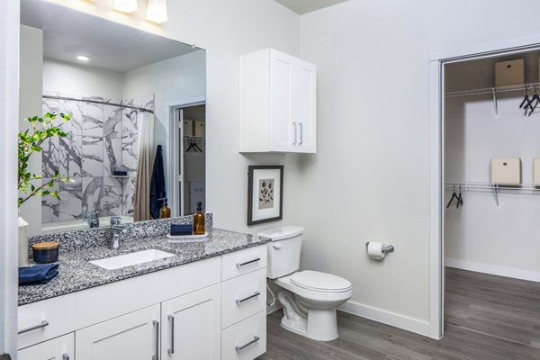Bathroom featuring modern fixtures and elegant quartz countertops at Prose Hardy Yards Apartments