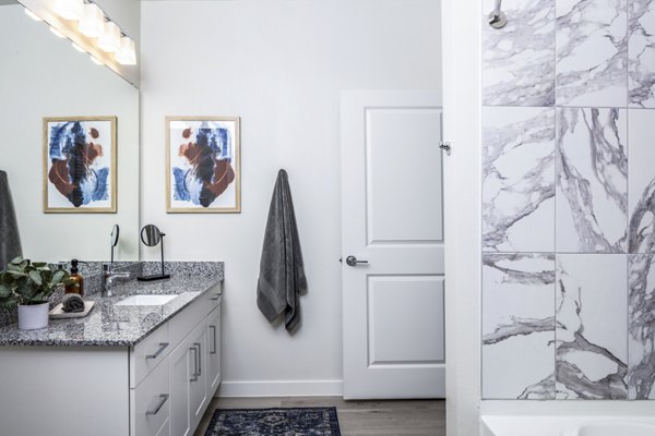 Modern bathroom with sleek fixtures and vanity at Prose Hardy Yards Apartments