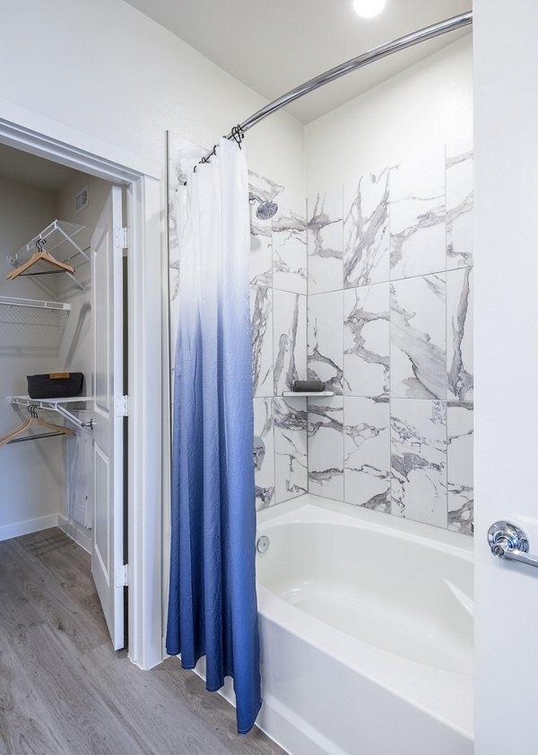 Bathroom showcasing modern fixtures and granite countertops in Prose Hardy Yards Apartments