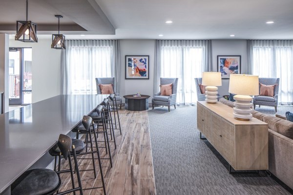 Clubhouse featuring modern design and cozy seating at Prose Hardy Yards Apartments