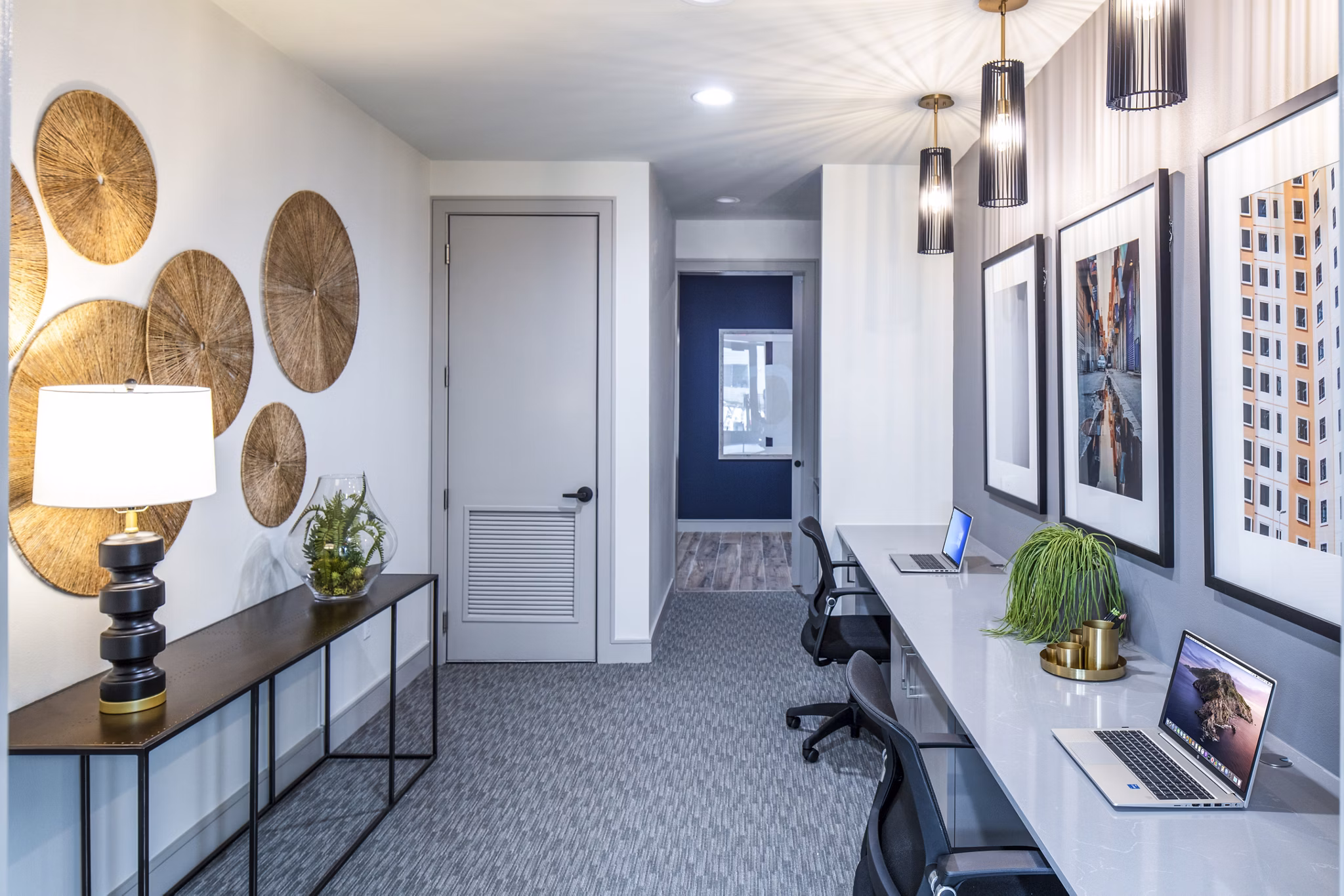 Clubhouse business center featuring modern workstations at Prose Hardy Yards Apartments