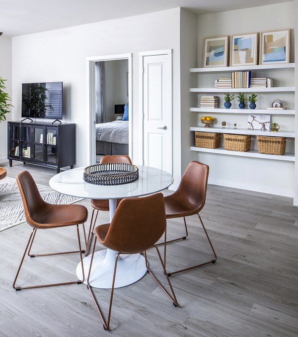 Dining room with elegant lighting and modern furniture at Prose Hardy Yards Apartments