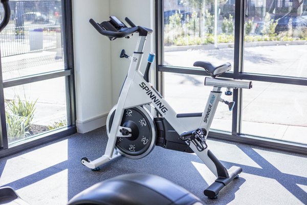 Spin studio with modern equipment at Prose Hardy Yards Apartments, offering fitness amenities for residents in stylish surroundings