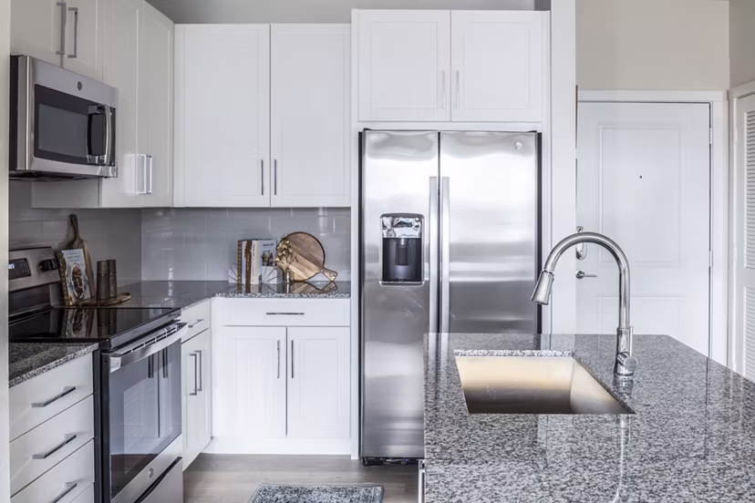 Modern kitchen with stainless steel appliances at Prose Hardy Yards Apartments