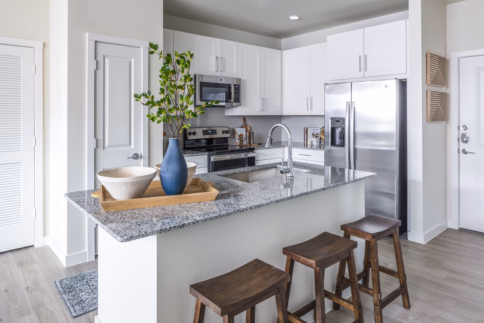 Modern kitchen with stainless steel appliances in Prose Hardy Yards Apartments luxury complex