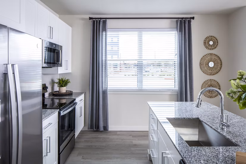 Modern kitchen with stainless steel appliances at Prose Hardy Yards Apartments