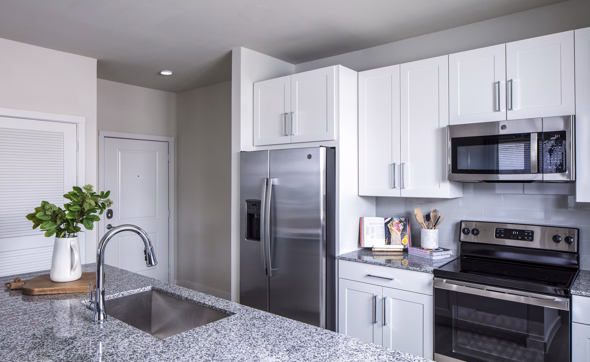 Modern kitchen with sleek countertops and stainless steel appliances at Prose Hardy Yards Apartments