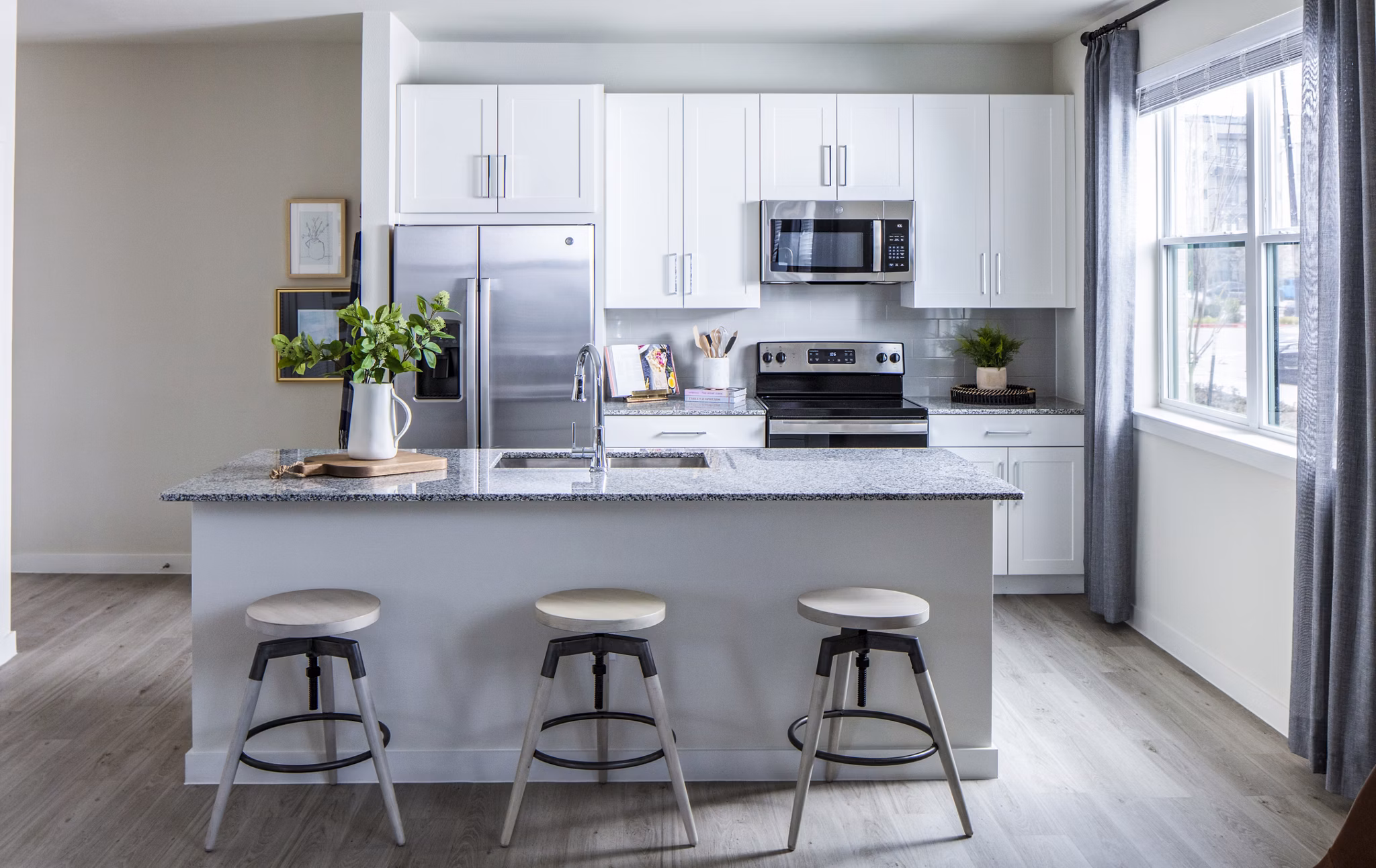 Spacious kitchen with sleek countertops and modern appliances at Prose Hardy Yards Apartments