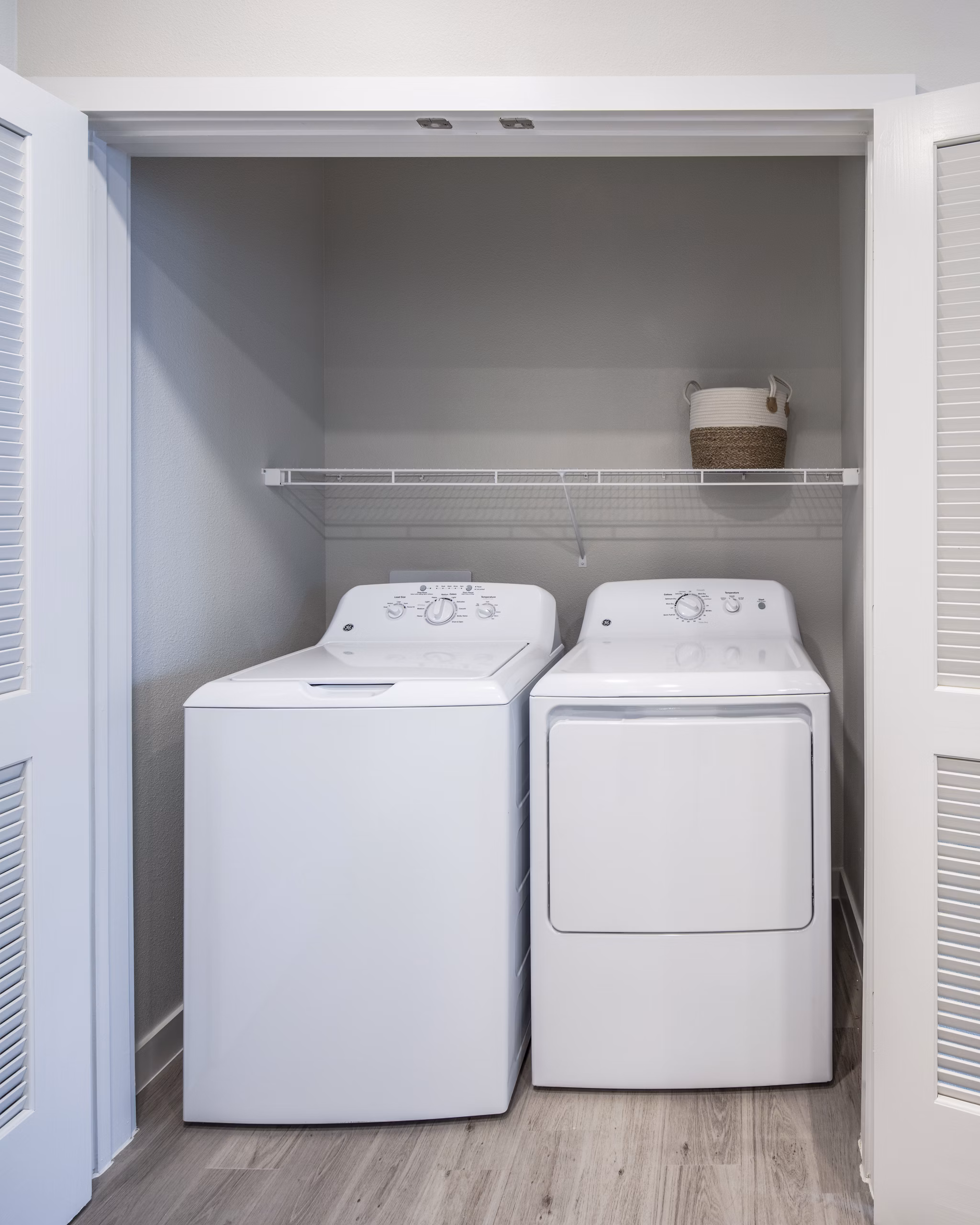 Laundry room with modern appliances at Prose Hardy Yards Apartments