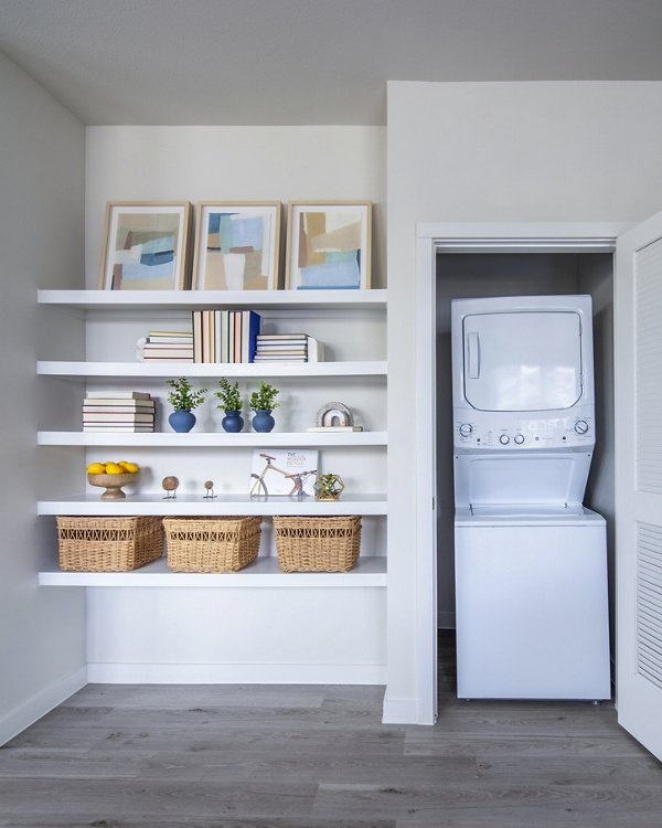 Laundry room with modern appliances at Prose Hardy Yards Apartments