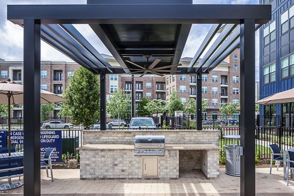 BBQ grill area on outdoor patio at Prose Hardy Yards Apartments, perfect for social gatherings and relaxation in a modern luxury setting