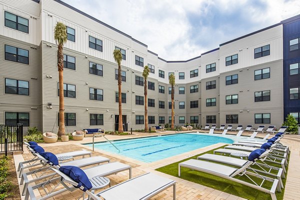 Rooftop pool surrounded by lush greenery at Prose Hardy Yards Apartments, offering luxury outdoor relaxation spaces