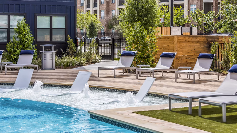 Inviting swimming pool with lounge chairs at Prose Hardy Yards Apartments
