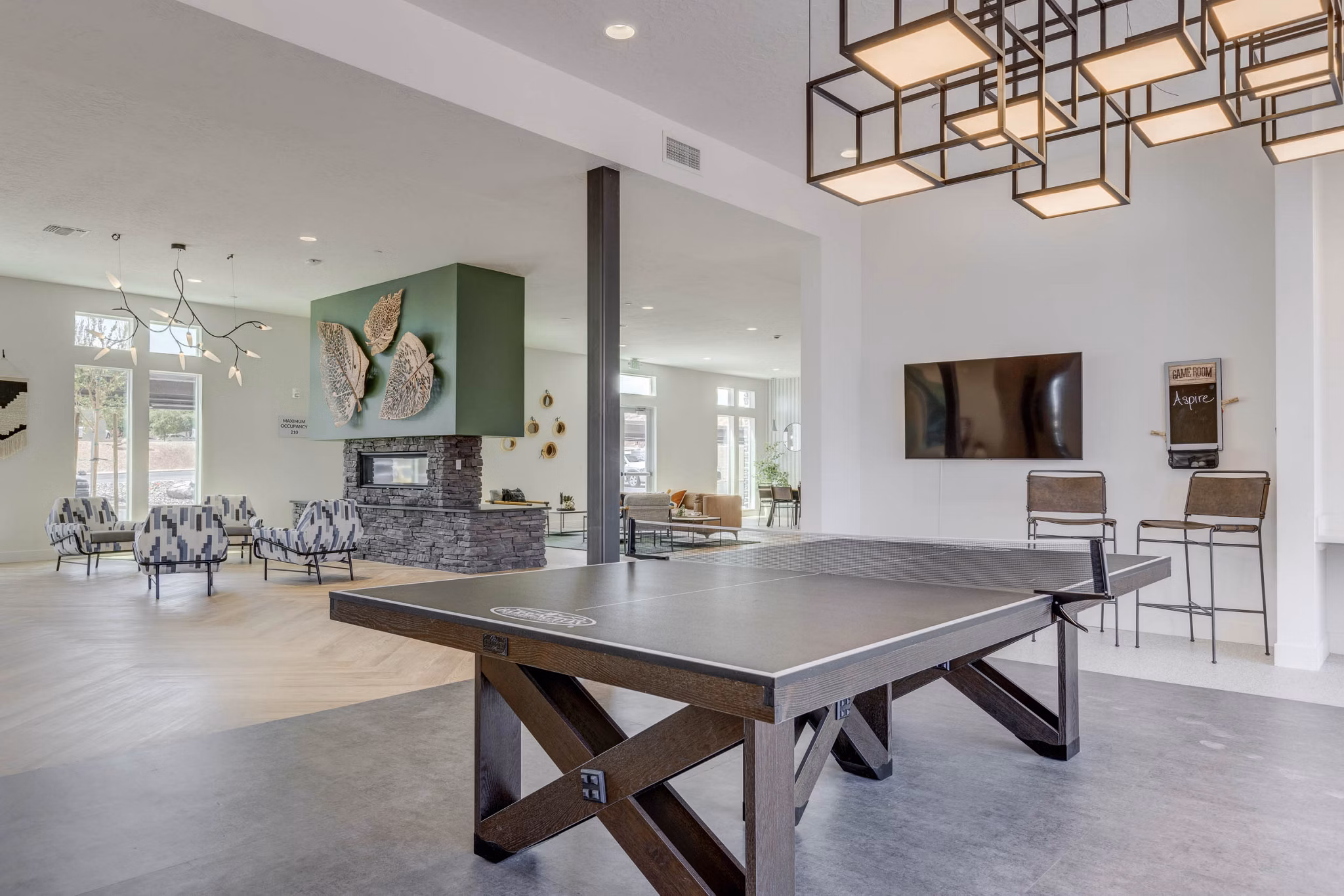 Modern game room with pool table and arcade games at Aspire Apartments, luxury community living