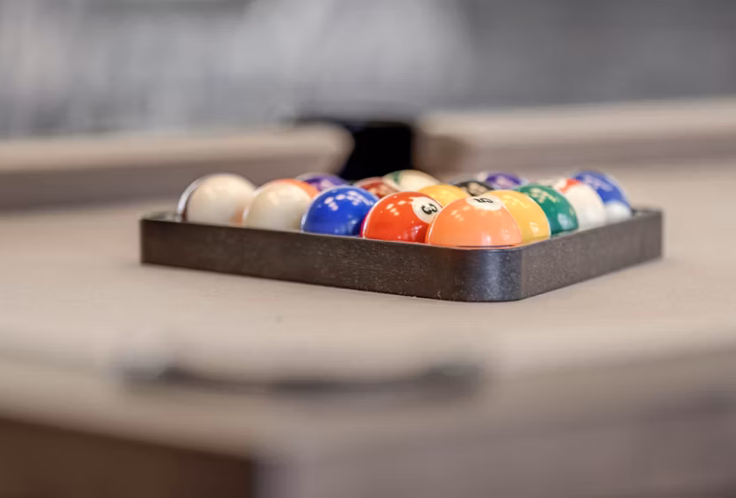 Billiard balls arranged on a pool table in luxury apartment game room