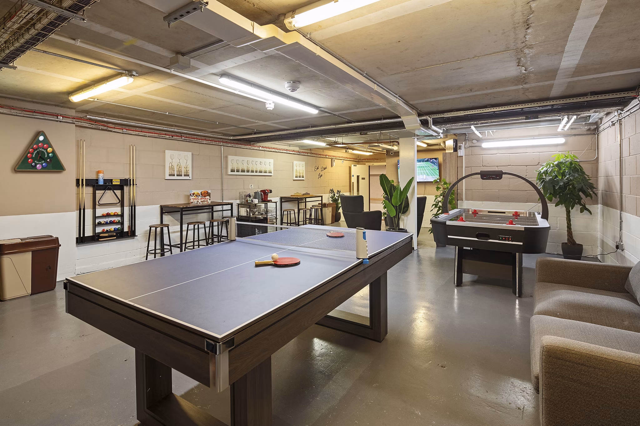 Community lounge featuring a billiards table, stylish seating areas, and a vibrant, welcoming atmosphere.