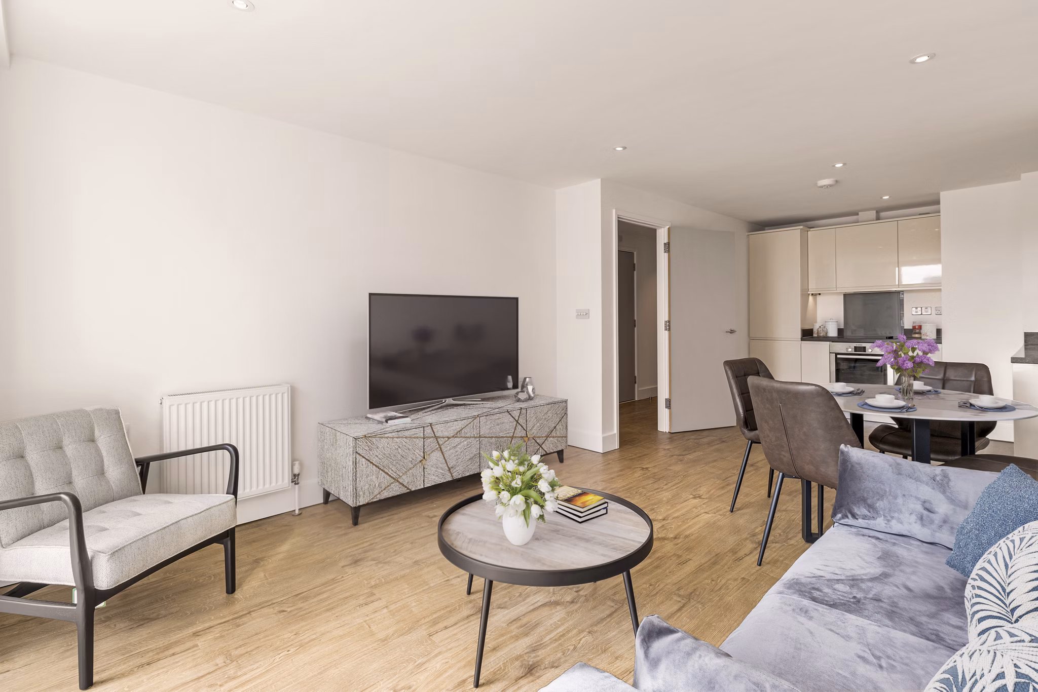 Bright and modern living room with a comfortable seating area and natural light pouring in through large windows.