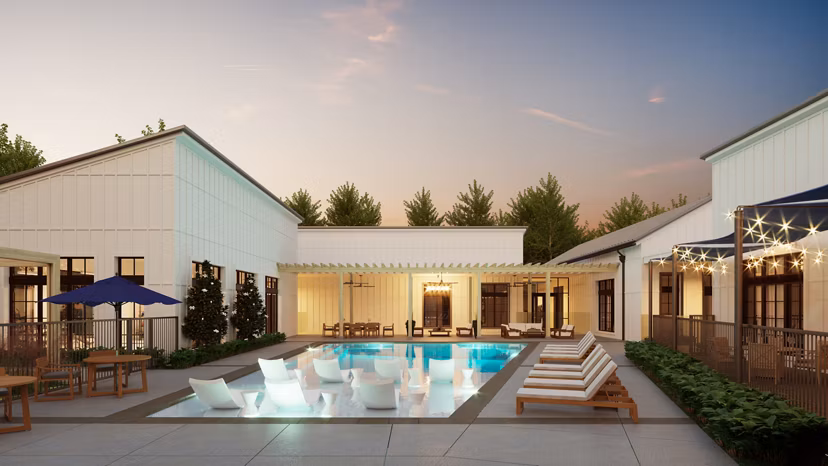 Pool surrounded by lush landscaping at Citizen House Kyle Apartments offering resort-style luxury living