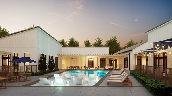 Pool surrounded by lush landscaping at Citizen House Kyle Apartments offering resort-style luxury living