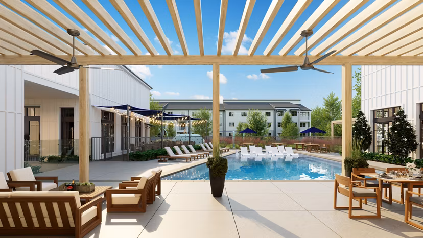 Spacious outdoor patio with modern seating and lush greenery at Citizen House Kyle Apartments