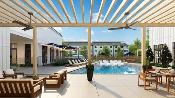 Spacious outdoor patio with modern seating and lush greenery at Citizen House Kyle Apartments