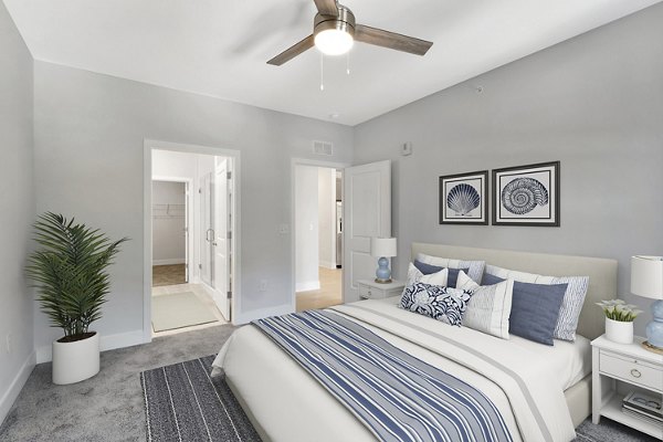 Bedroom with modern furnishings at Aquatera Apartments in San Diego