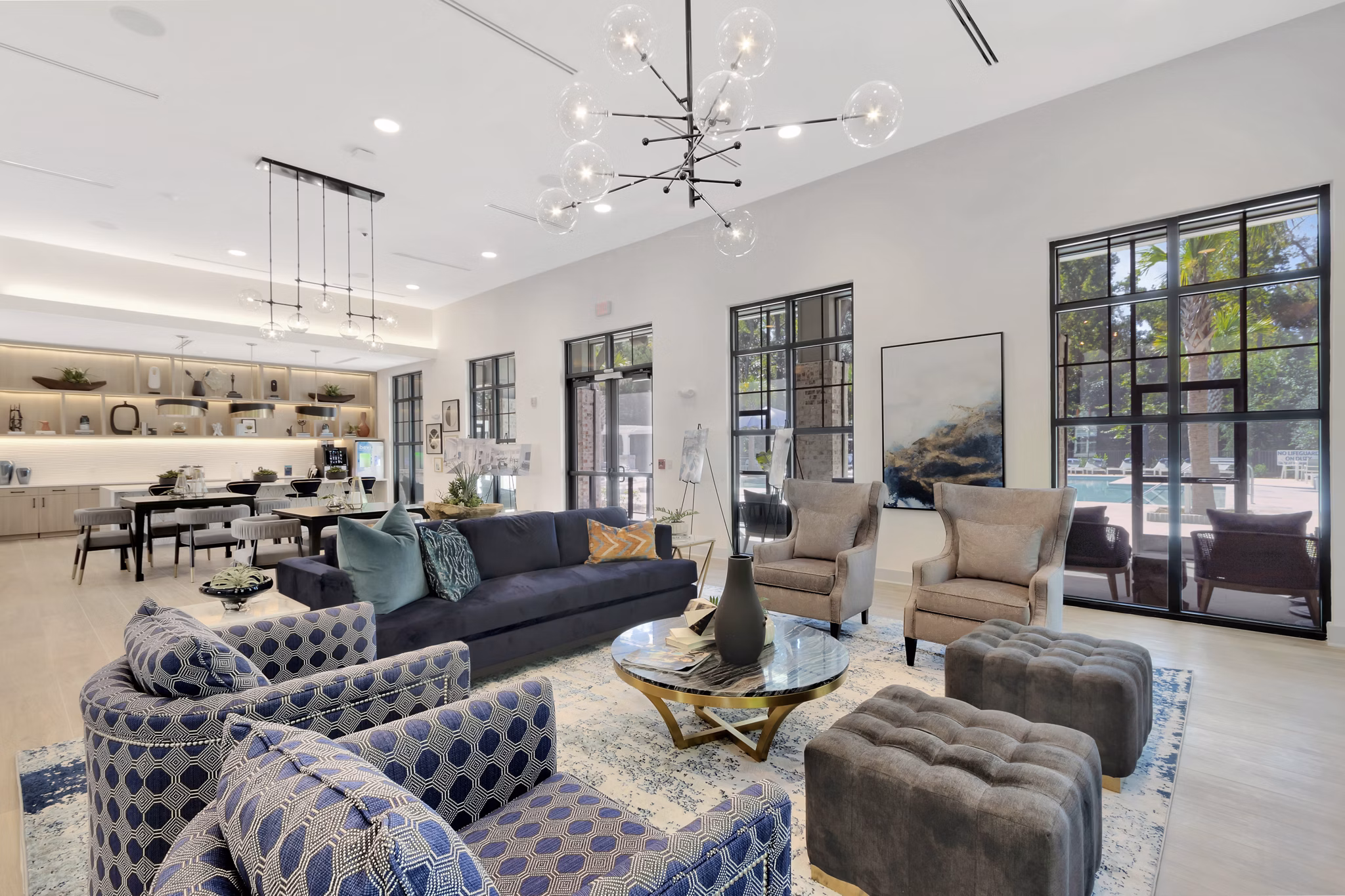 Aquatera Apartments: Stylish clubhouse with modern decor and comfortable seating areas, ideal for relaxation and social gatherings