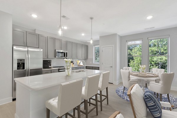 Modern kitchen with stainless steel appliances at Aquatera Apartments