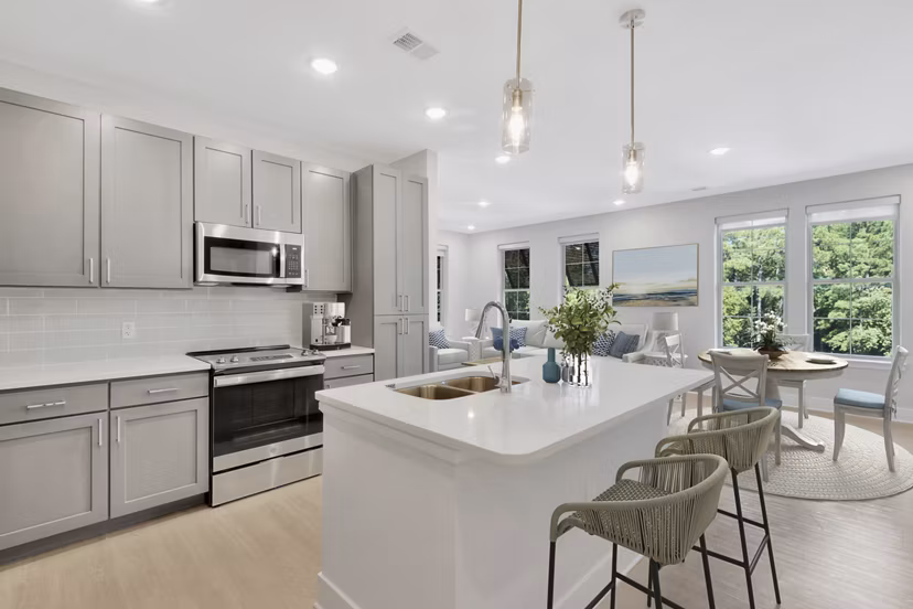 Modern kitchen with stainless steel appliances in Aquatera Apartments, luxury living redefined by Greystar in a vibrant community setting