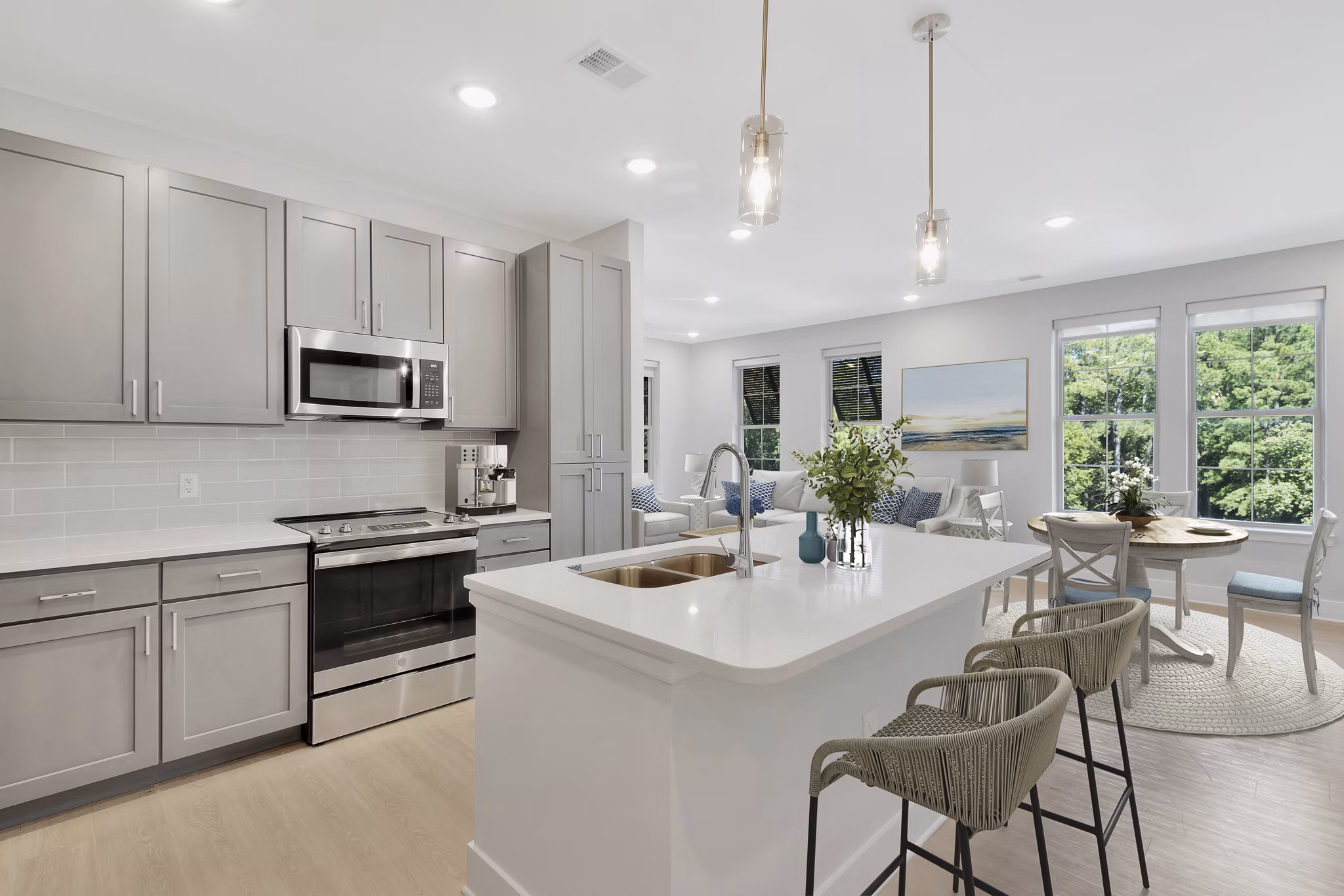 Modern kitchen with stainless steel appliances in Aquatera Apartments, luxury living redefined by Greystar in a vibrant community setting